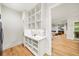 Butler's pantry with storage shelves, marble countertop, and hardwood floors at 6175 River Shore Pkwy, Atlanta, GA 30328