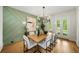 Dining room with a statement wall, hardwood floors and French doors leading to the backyard at 6175 River Shore Pkwy, Atlanta, GA 30328
