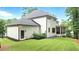 Pristine white brick home exterior with a lush green lawn and a black trim for a classic, modern look at 6175 River Shore Pkwy, Atlanta, GA 30328