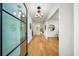 Bright foyer with hardwood floors, modern lighting and a glass front door at 6175 River Shore Pkwy, Atlanta, GA 30328