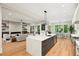 Open concept kitchen featuring a quartz island and stainless appliances that flows into the living room at 6175 River Shore Pkwy, Atlanta, GA 30328