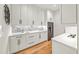 Bright kitchen features herringbone tile backsplash, white cabinets, and marble countertop at 6175 River Shore Pkwy, Atlanta, GA 30328