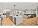 Open kitchen with an island and stainless appliances that flows into the living room with fireplace at 6175 River Shore Pkwy, Atlanta, GA 30328