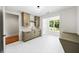 Laundry room featuring marble floors, built-in storage, sink, and a bright window with outdoor views at 6175 River Shore Pkwy, Atlanta, GA 30328