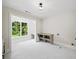 A bright laundry room with a large window, tiled floors, counter and storage at 6175 River Shore Pkwy, Atlanta, GA 30328
