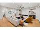Open concept living room featuring a modern fireplace, hardwood floors, and neutral furnishings at 6175 River Shore Pkwy, Atlanta, GA 30328
