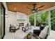 Covered patio with fireplace, ceiling fan, and comfortable seating area at 6175 River Shore Pkwy, Atlanta, GA 30328