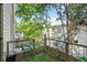 Outdoor space features artificial turf, metal railing, and surrounding views of trees and backyard at 1271 Mackintosh Nw Park # 30, Atlanta, GA 30318