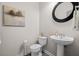 Elegant powder room featuring a pedestal sink, modern fixtures, and a decorative mirror at 1271 Mackintosh Nw Park # 30, Atlanta, GA 30318