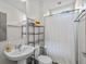 Clean bathroom featuring a vanity sink, toilet, mirror and shower with a curtain rod at 1271 Mackintosh Nw Park # 30, Atlanta, GA 30318