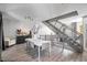 Dining area with a modern table, sleek chairs, and an open staircase to the upper level at 1271 Mackintosh Nw Park # 30, Atlanta, GA 30318