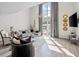 Sunlit living room with high ceilings, large windows, and contemporary decor at 1271 Mackintosh Nw Park # 30, Atlanta, GA 30318