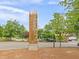 View of the entrance monument sign for Westside Village Shopping Center with a tree-lined street at 1271 Mackintosh Nw Park # 30, Atlanta, GA 30318