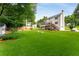 Large, well-manicured backyard with a spacious lawn and view of the home's deck and screened-in porch at 2401 Stockton Dr, Marietta, GA 30066