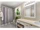 Bright bathroom features a large mirror, a shower with gray curtain and a window at 2401 Stockton Dr, Marietta, GA 30066