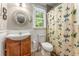 Stylish bathroom featuring floral shower curtain, wood vanity and stylish fixtures at 2401 Stockton Dr, Marietta, GA 30066