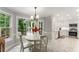 Sunny dining room with marble tile flooring, classic furniture, and backyard views leading into the kitchen at 2401 Stockton Dr, Marietta, GA 30066
