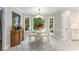 Bright dining room with white marble floors, elegant table, and beautiful natural light from backyard view at 2401 Stockton Dr, Marietta, GA 30066