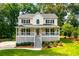 Charming two-story home featuring a spacious front porch, lush landscaping, and a welcoming curb appeal at 2401 Stockton Dr, Marietta, GA 30066