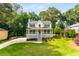 Inviting two-story home with a covered front porch, mature trees, and a beautifully maintained yard at 2401 Stockton Dr, Marietta, GA 30066