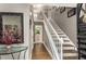 Grand foyer showcasing a staircase, hardwood floors, and elegant decor with a view of the dining room at 2401 Stockton Dr, Marietta, GA 30066