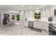 Open kitchen layout with stainless steel appliances, white cabinets, and adjacent dining area at 2401 Stockton Dr, Marietta, GA 30066