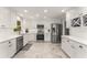 Bright kitchen with stainless steel appliances, custom white cabinets and marble floor at 2401 Stockton Dr, Marietta, GA 30066