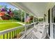 Inviting front porch with comfortable seating, hanging plants, and a view of the lush front yard at 2401 Stockton Dr, Marietta, GA 30066