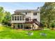 Home's rear exterior with deck, screened porch, patio area, and a big yard with gardening beds at 2401 Stockton Dr, Marietta, GA 30066