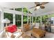 Sunroom filled with natural light, wicker furniture, ceiling fan, and backyard views at 2401 Stockton Dr, Marietta, GA 30066
