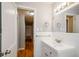 Bathroom featuring white tiles, sink, vanity, mirror, and fixtures at 2895 Akron St, Atlanta, GA 30344
