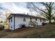 Exterior view of the home featuring white siding, a side entrance, and a well-maintained lawn at 2895 Akron St, Atlanta, GA 30344