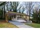 Charming home featuring a carport and landscaped front yard on a sunny day at 2895 Akron St, Atlanta, GA 30344
