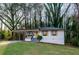 Charming home with carport, featuring white siding, yellow accents and a well-manicured front lawn at 2895 Akron St, Atlanta, GA 30344