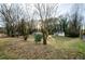 A quiet street view leading up to a well-maintained home with mature trees in the yard at 2895 Akron St, Atlanta, GA 30344