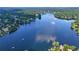 This aerial view showcases houses with lake access and docks on a beautiful lake surrounded by lush landscapes at 4030 Greatwood Path, Alpharetta, GA 30005