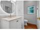 Elegant bathroom with marble countertop, modern fixtures, and paneled walls at 4030 Greatwood Path, Alpharetta, GA 30005