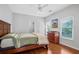 This bedroom has hardwood floors, natural light, and a ceiling fan at 4030 Greatwood Path, Alpharetta, GA 30005