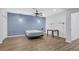 Bedroom features luxury vinyl plank floors, ceiling fan, lighting, and a blue accent wall at 4030 Greatwood Path, Alpharetta, GA 30005