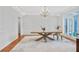 Bright dining room boasts hardwood floors, a modern chandelier, and sophisticated wainscoting at 4030 Greatwood Path, Alpharetta, GA 30005