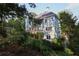 Charming home exterior with a deck and beautifully landscaped garden and greenery at 4030 Greatwood Path, Alpharetta, GA 30005