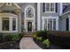 Inviting front entrance with stone steps, arched window, and mature landscaping at 4030 Greatwood Path, Alpharetta, GA 30005