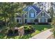 Beautiful two-story home with lush front yard landscaping and a curved driveway at 4030 Greatwood Path, Alpharetta, GA 30005