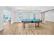 Spacious game room with pool table, wood floors, chandelier, and access to the outside at 4030 Greatwood Path, Alpharetta, GA 30005