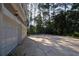 Two-car garage and additional parking space featuring a basketball hoop at 4030 Greatwood Path, Alpharetta, GA 30005