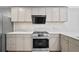 Kitchen with stainless steel appliances, modern cabinets, and quartz countertops and backsplash at 4030 Greatwood Path, Alpharetta, GA 30005