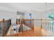 Upper landing featuring wood floors, wrought iron railing and tray ceiling at 4030 Greatwood Path, Alpharetta, GA 30005