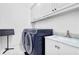 Laundry room features side-by-side machines, white cabinets, and a marble countertop sink at 4030 Greatwood Path, Alpharetta, GA 30005