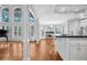 Open-concept living room with hardwood floors, fireplace, tall windows, and white columns at 4030 Greatwood Path, Alpharetta, GA 30005