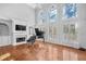Bright living room features a fireplace, built-in shelves, a piano, and large windows at 4030 Greatwood Path, Alpharetta, GA 30005